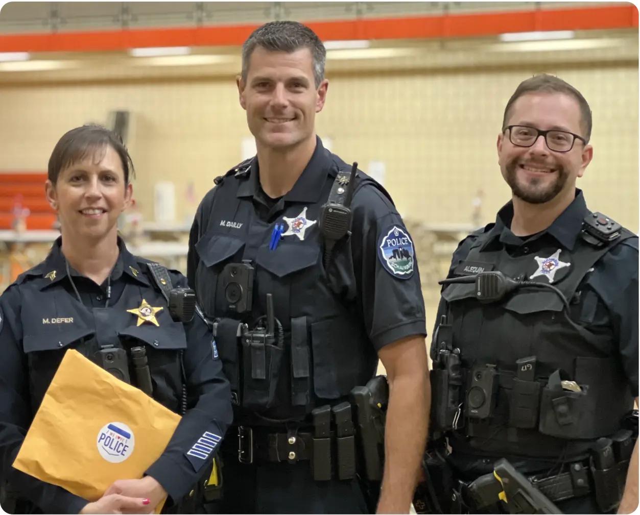 Police officers receiving appreciation letters from church volunteers as part of community service for churches