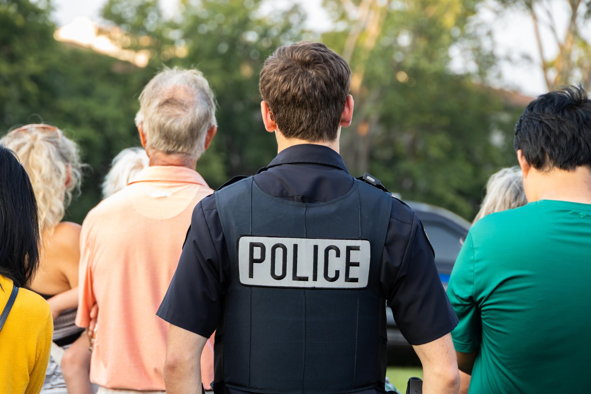 Police officer standing on a city street representing law enforcement support