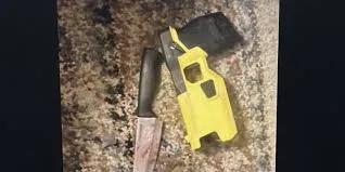 Evidence photo of a kitchen knife and a yellow Axon Taser used by South Brunswick police.