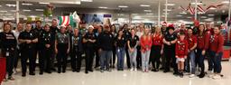 Officers from the Clearwater Police Department posing with children and community partners at the Clearwater Mall Target in Florida.