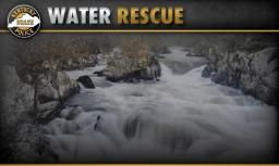 Graphic overlay reading water rescue with Kentucky State Police emblem over a fast flowing rocky river scene.