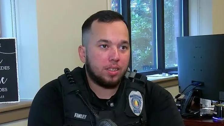 Anniston Police Department Officer Jeffrey Finley sitting at his desk in uniform.