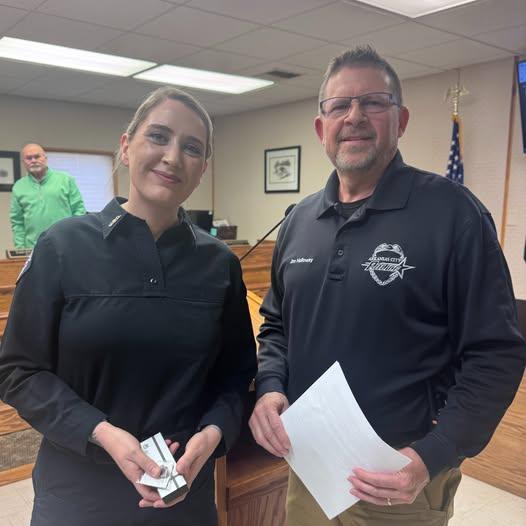 Police Chief Jim Holloway standing with Master Police Officer Shannese McIntosh at an Arkansas City KS award ceremony.