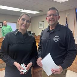 Police Chief Jim Holloway standing with Master Police Officer Shannese McIntosh at an Arkansas City KS award ceremony.