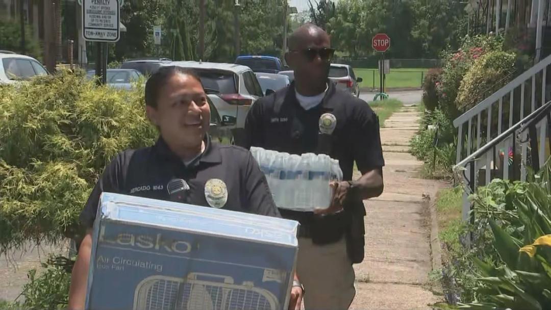 Two Camden police officers from the Community Outreach Unit provide assistance during a summer heatwave.