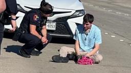 Plano Police Officer Rust kneeling beside teen holding flowers after Easter Sunday crash