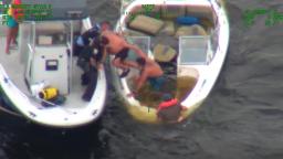 St. Cloud Police and Osceola County Sheriff deputies pulling passengers from a partially submerged boat during a water rescue mission