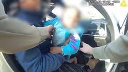 Trooper Warren performing infant first aid during traffic stop
