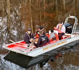 A happy dog on a boat after being saved from a Waccamaw River island in Longs, SC.