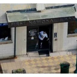 Aerial drone view of the Community Banks entrance in Arvada, CO as a robbery suspect exits through the front doors.