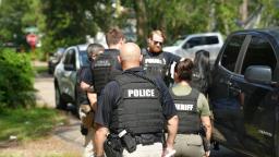 Florida law enforcement officers and FDLE police wearing tactical vests outdoors during Operation Statewide Shield.