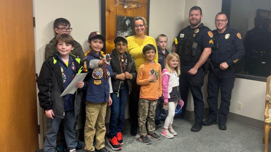 Everett police officers and Olivia Park Elementary students smiling together