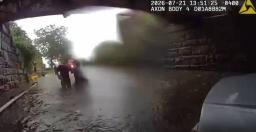 Milford CT police officer bodycam footage showing water rescue under a bridge during flash flooding.