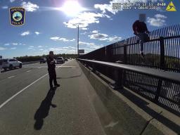 Body camera footage still of Groton Police officers talking to a man on the Gold Star Bridge.