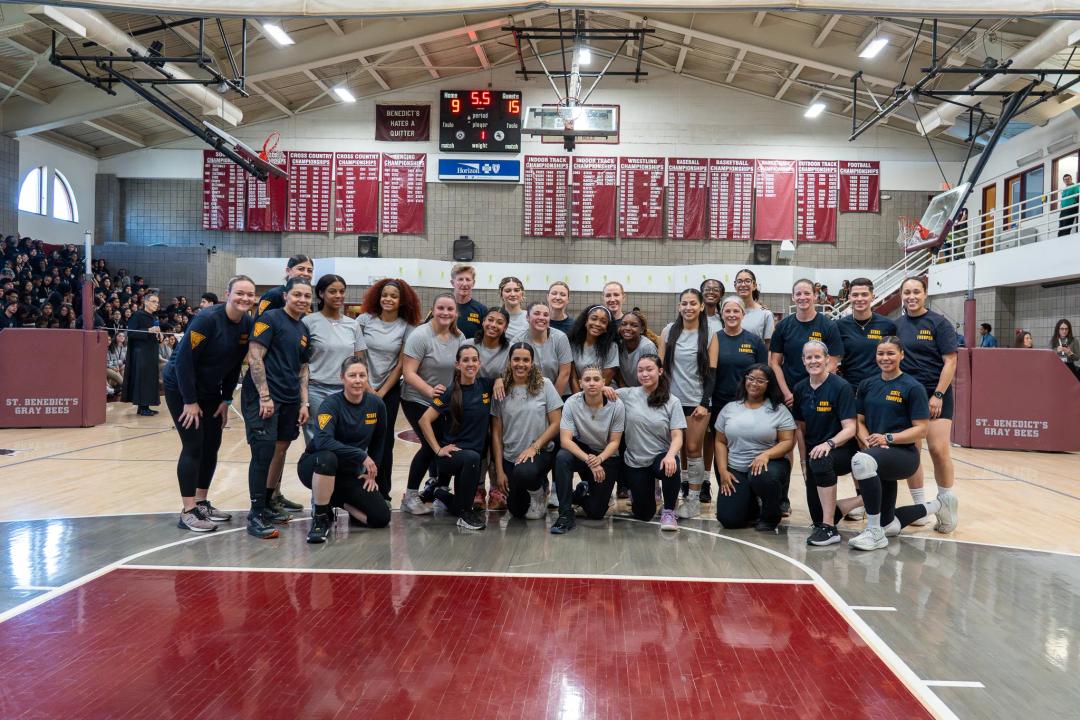 NJSP female troopers and Newark, NJ St. Benedict's Prep girls posing for a group picture after a volleyball game