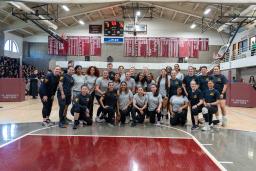 NJSP female troopers and Newark, NJ St. Benedict's Prep girls posing for a group picture after a volleyball game