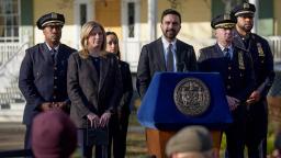 NYPD Chief Aaron Edwards and Sgt. Luis Navarro standing with Mayor Mamdani at a press conference in New York.