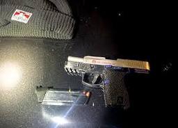 Evidence photo showing a silver and black handgun and a magazine with bullets, recovered by SRPD officers.