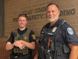 Clay County Sheriff Deputy Chase Blatt and KCPD Detective Jason Findley standing together outside the Clay County Public Safety Building.
